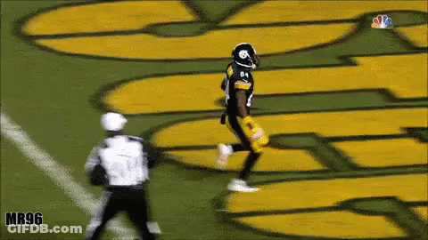 Football Player Running Near Mr96 Sign GIF