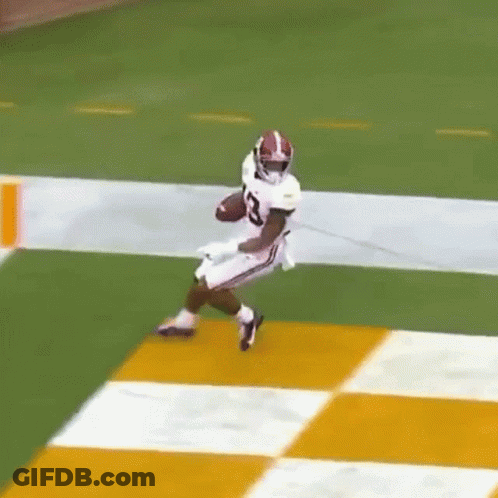 Football Player Running With Ball On Checkered Field GIF
