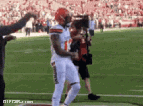 Football Player Running With Cameraman GIF