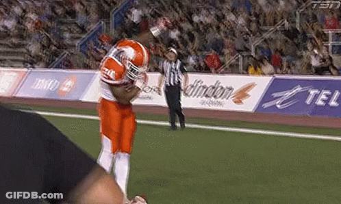 Football Player Running With Referee Behind GIF