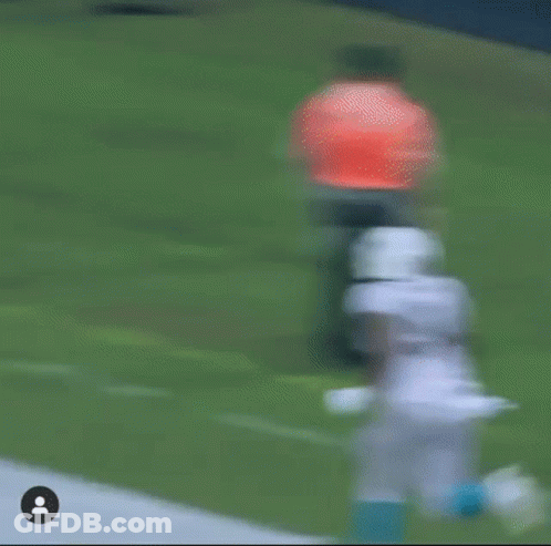 Football Player Running With Referee Behind GIF