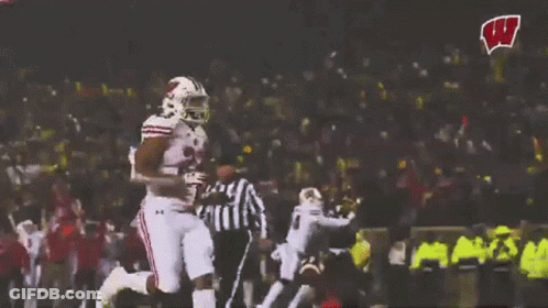 Football Player Running With W Logo In Background GIF