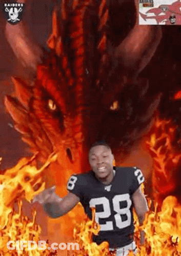 Football Player Standing In Front Of Dragon Surrounded By Flames GIF