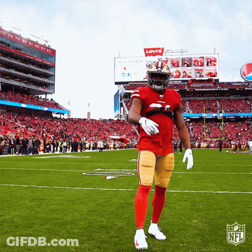 Football Player Standing In Front Of Levi's Sign GIF
