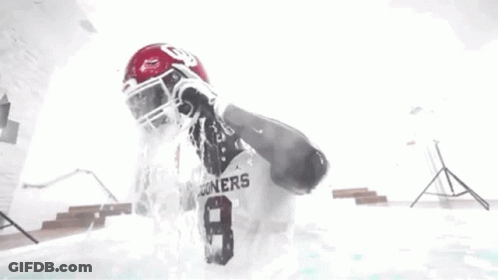 Football Player Standing In Pool With Water Pouring On Head GIF