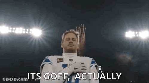 Football Player Standing With Hands Folded In Front Of Fireworks GIF
