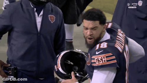 Football Player Stands On Field Saying That Playful GIF