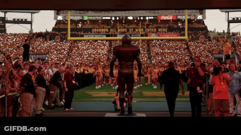 Football Player Statue In Front Of Coca-Cola Ad GIF