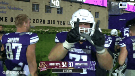 Football Player Thumbs Up In Front Of Big Ten Live Scoreboard GIF