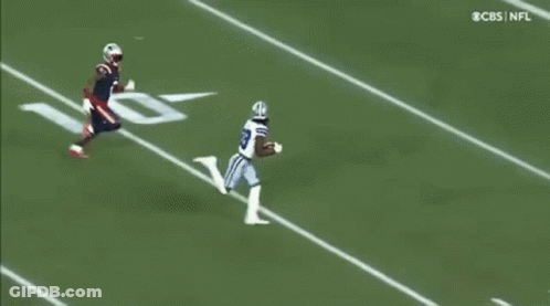 Football Player Trying To Catch Ball While Being Tackled GIF