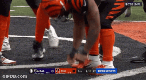 Football Player Tying Shoes On Field GIF