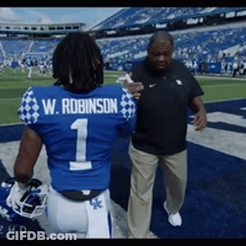 Football Player W Robinson Talking To Coach GIF