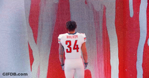 Football Player Walker In Front Of Red Wall GIF