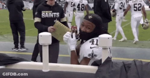 Football Player Wearing Mask Holding Soda GIF