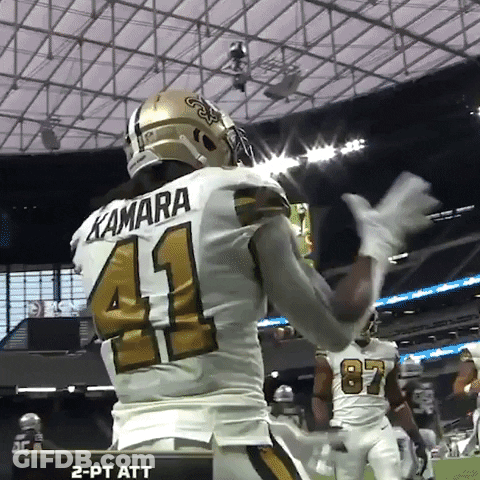 Football Player With Dreadlocks Signing Glove In Locker Room GIF