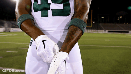 Football Player With H Helmet In Front Of Two Bobcats Logos GIF