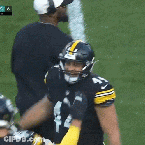 Football Player With Helmet And Coach Behind GIF
