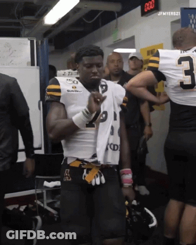 Football Player With Jersey Number 3 In Locker Room GIF