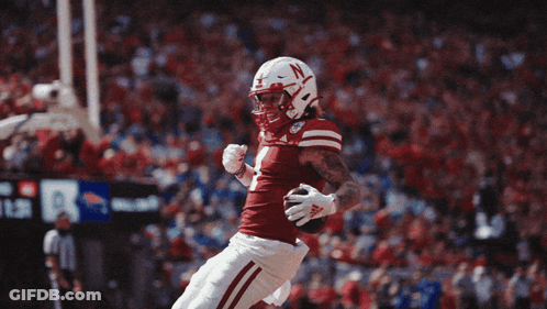 Football Player With N On Helmet Jumping GIF