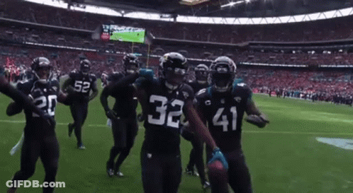 Football Players 32 And 41 Celebrating On Field GIF