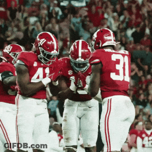 Football Players Dancing In Front Of Man In Suit GIF