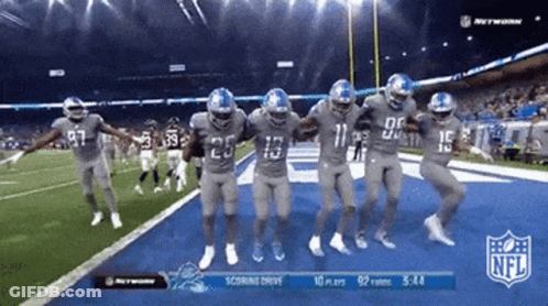 Football Players Dancing In Front Of NFL Scoreboard GIF