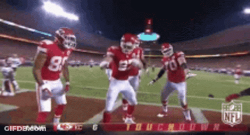 Football Players Dancing On Field With NFL Logo GIF