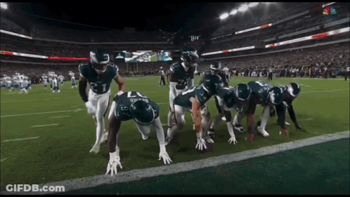 Football Players Getting Ready To Run GIF