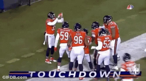 Football Players Huddled Together On Field GIF