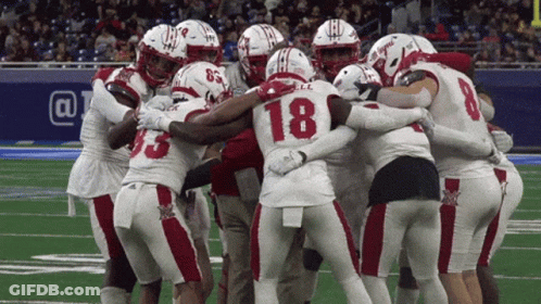 Football Players Huddled With Number 18 GIF