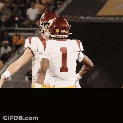 Football Players Hugging In Trojans Uniforms GIF