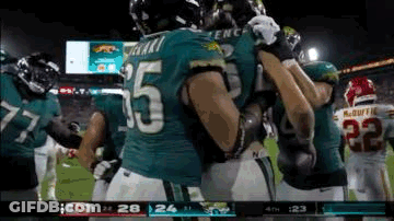 Football Players Hugging On Field GIF