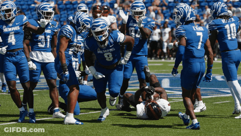Football Players In Blue Memphis Uniforms GIF