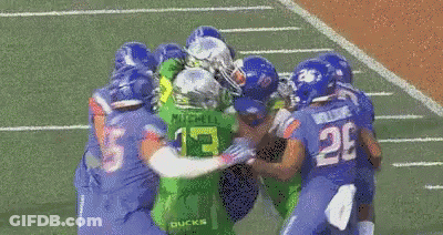Football Players In Blue Uniforms With Number 55 GIF