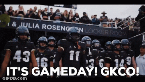 Football Players In Front Of It's Gameday Sign GIF