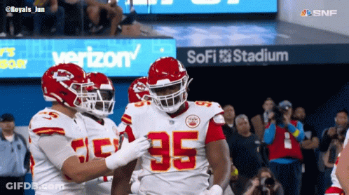 Football Players In Front Of SoFi Stadium Sign GIF
