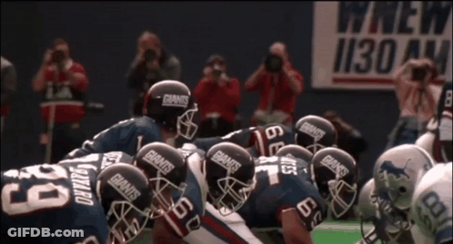 Football Players In Giants Helmets Huddling GIF