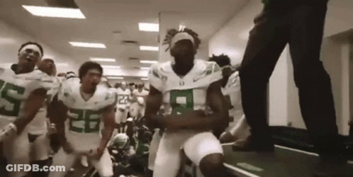 Football Players In Green And White Dancing In Hallway GIF