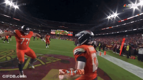 Football Players In Helmets Standing Together GIF