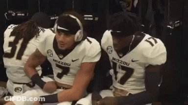 Football Players In Locker Room One With Headphones GIF