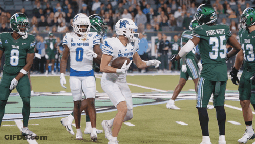 Football Players In Memphis Uniforms On Field GIF