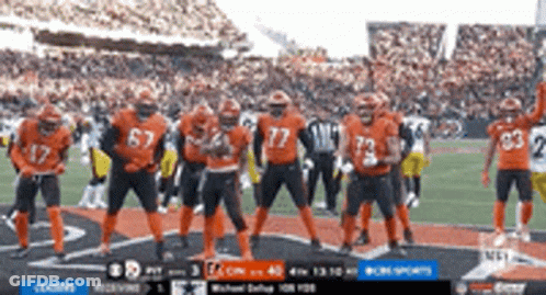 Football Players In Orange Uniforms On Field GIF