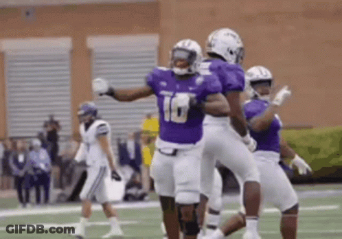 Football Players In Purple And White Celebrating Touchdown GIF