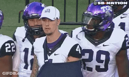 Football Players In Purple And White Uniforms Number 29 GIF