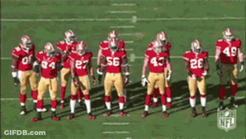 Football Players In Red And Gold Uniforms Number 56 GIF