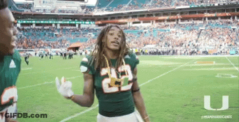 Football Players In Red And White Uniforms Huddled Together GIF