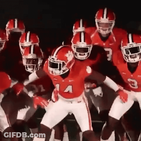 Football Players In Red Uniforms Dancing Together GIF