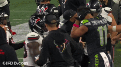 Football Players Including Number 11 Huddled Together GIF