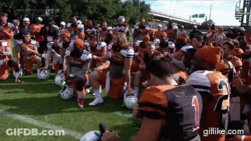 Football Players Kneeling On Field With Number 2 Jersey GIF