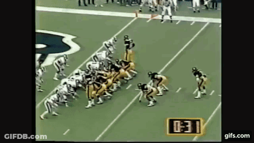 Football Players Lined Up On Field With Clock Showing 10:31 GIF